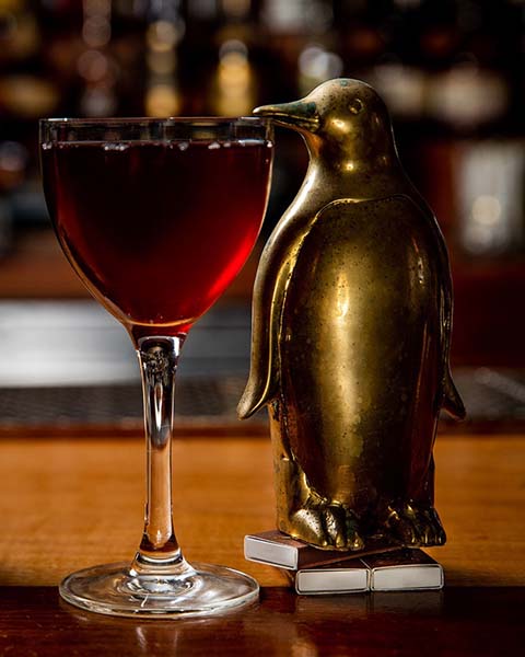 Penguine statue sneaking a drink.