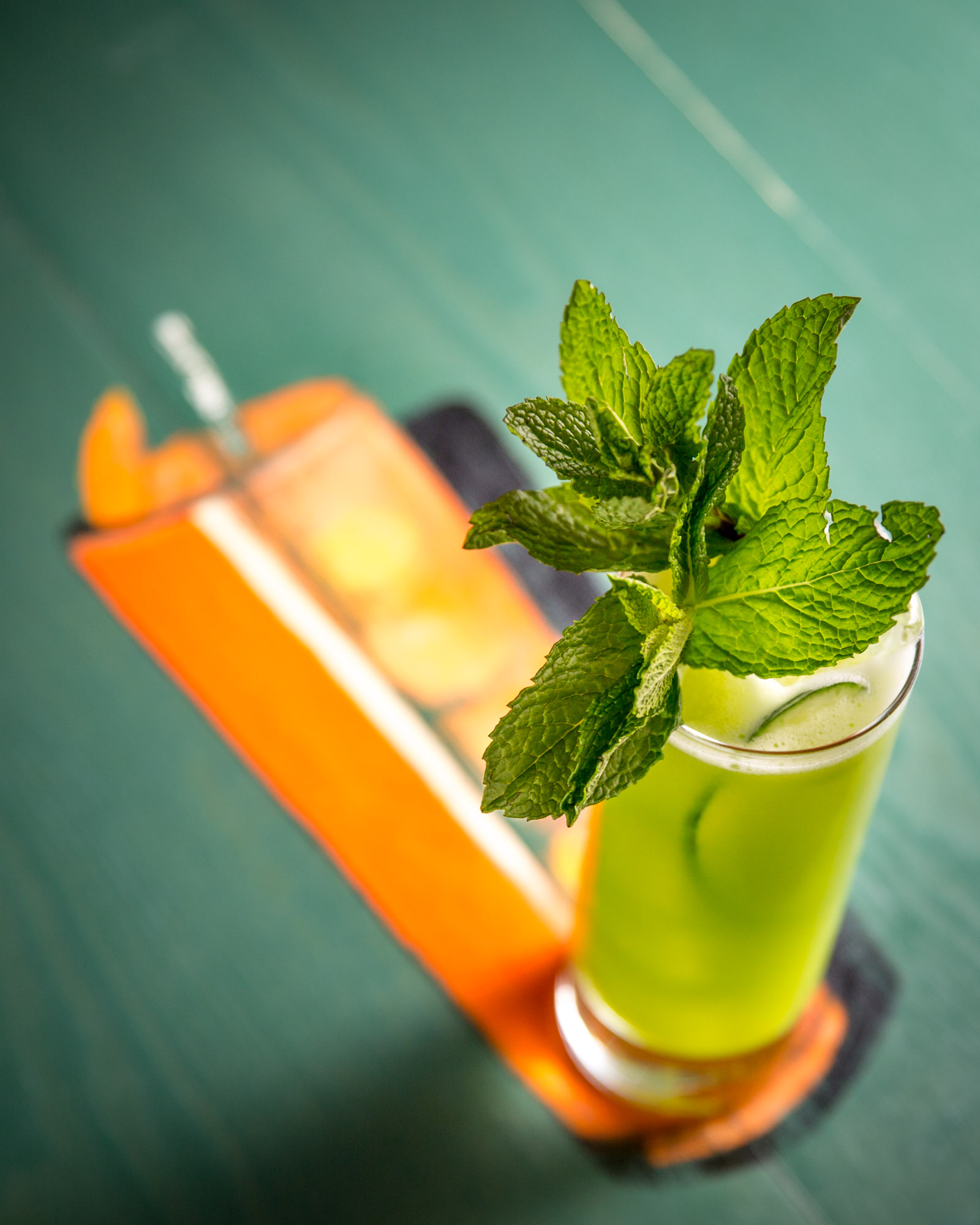 dramatic cocktail photographed against it's painted reflection